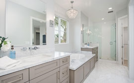 His and her vanities surround the soaking tub