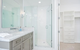 Custom master shower with frameless glass, shower bench and designer Delta facuets