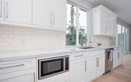 Charming shacker cabinets and oversized countertops with recessed appliances